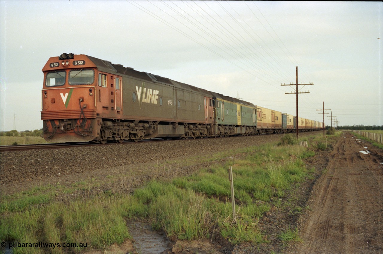 127-24
Deer Park West, broad gauge V/Line G class G 512 Clyde Engineering EMD model JT26C-2SS serial 84-1240 leads Australian National BL class BL 27 Clyde Engineering EMD model JT26C-2SS serial 83-1011 with a down Adelaide bound goods train waiting for line clear at the end of the double track.
Keywords: G-class;G512;Clyde-Engineering-Rosewater-SA;EMD;JT26C-2SS;84-1240;