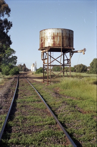 127-35
Elmore water tank, mainline looking south towards Elmore station yard, 207 km post, the right hand side out loading pipe was for the Cohuna line.
