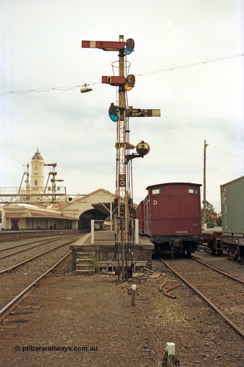 128-03
Ballarat station yard view, station platform, semaphore signal post 20, Z van in dock, looking towards station building, signal gantry and canopy.
