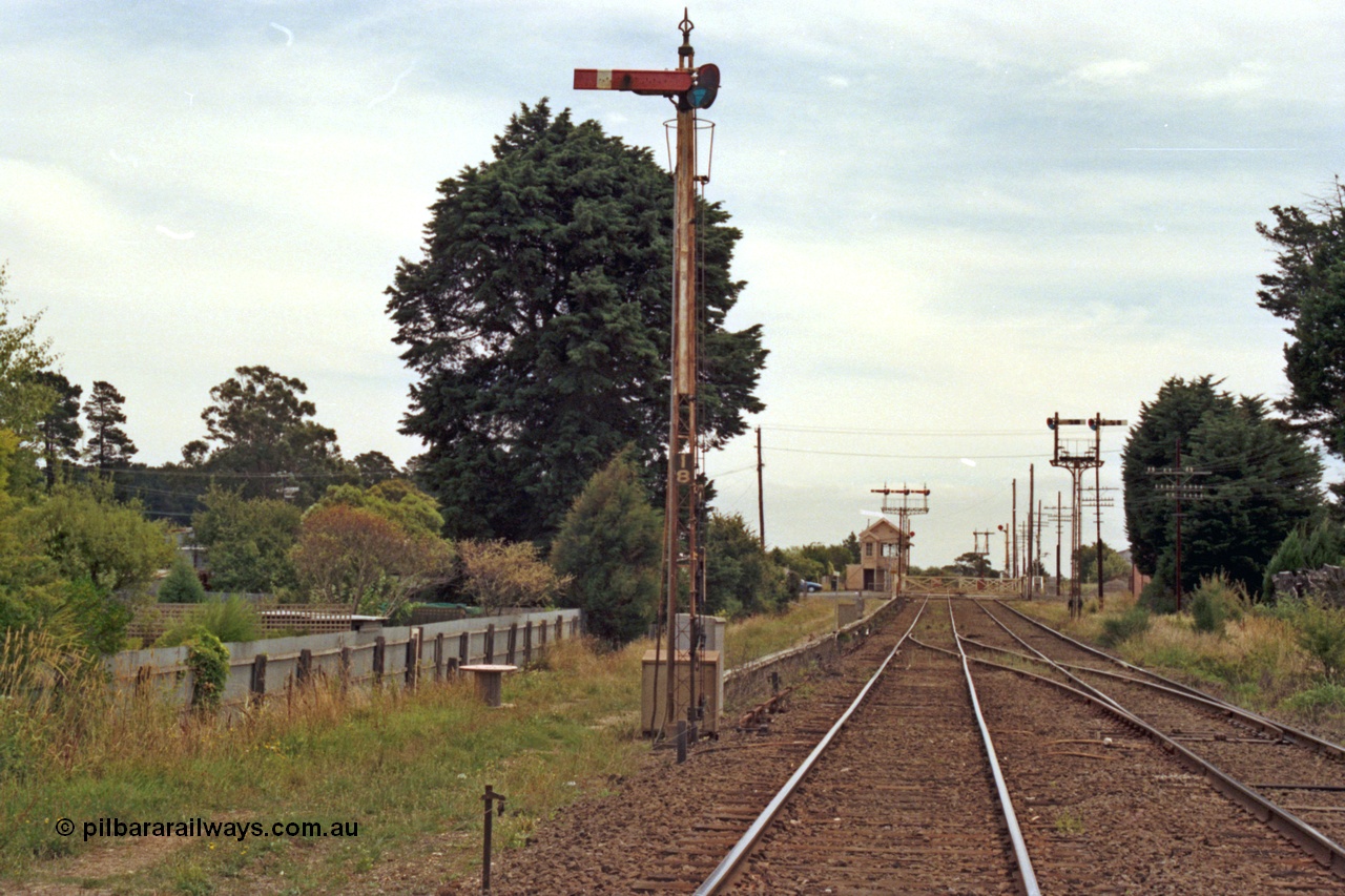 128-07
Ballarat, Linton Junction or Ballarat D signal box, semaphore signal Post 18, looking west at interlocked gates for Gillies Street grade crossing, crossover for up trains ex cattle yard and Linton line to Up line, semaphore signal posts for up and down lines in background.
