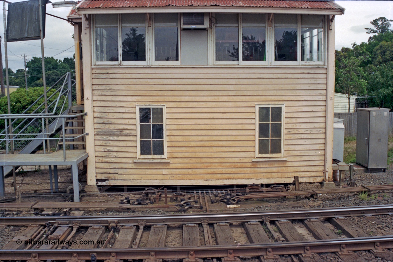 128-08
Ballarat, Linton Junction or Ballarat D signal box, detail view from track side, front elevation, point rodding, interlocking and signal wires, staff exchange platform at left of box, points for Timken's Sidings.
