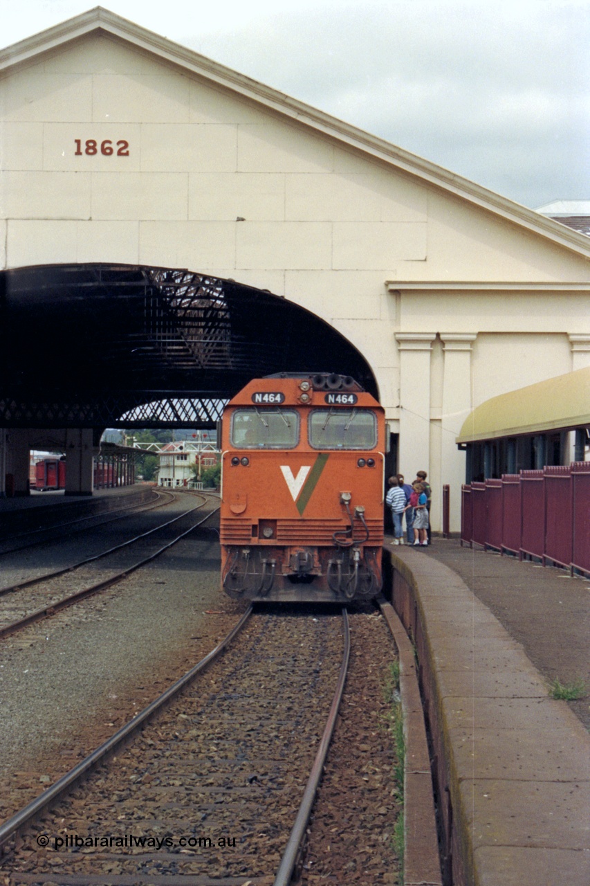 128-12
Ballarat station, V/Line broad gauge N class N 464 'City of Geelong' Clyde Engineering EMD model JT22HC-2 serial 86-1193 with a down arrival, station canopy with date of 1862, shows the modified 3 roads, formally 4 roads ran through the station.
Keywords: N-class;N464;Clyde-Engineering-Somerton-Victoria;EMD;JT22HC-2;86-1193;