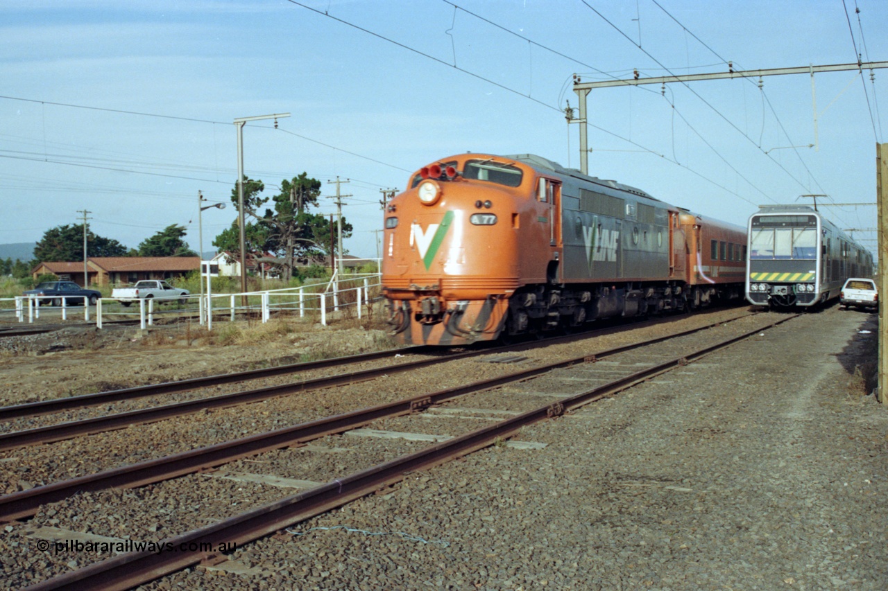 128-25
Nar Nar Goon, V/Line broad gauge A class A 77 'Ian Stewart' Clyde Engineering EMD model AAT22C-2R serial 83-1181 rebuilt from B class B 77 Clyde Engineering EMD model ML2 serial ML2-18 with an up passenger train passes the new and under test 4D (Double Deck Development and Demonstration) double deck suburban electric train, test runs. A 77 was named after Australian rules footballer 'Ian Stewart' 09/1984, the green plaque is visible below the drivers window.
Keywords: A-class;A77;Clyde-Engineering-Rosewater-SA;EMD;AAT22C-2R;83-1181;rebuild;bulldog;