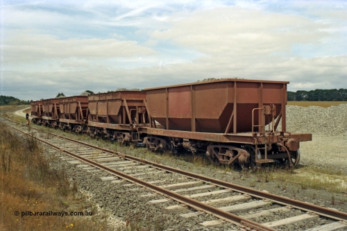 128-11
Ballarat, ballast loading site on the former Linton Line near Ring Road, five loaded V/Line broad gauge VZMA type bogie ballast waggons VZMA 85 and others. VZMA 85 was built at Newport Workshops in 09/1950 as an NN class bogie ballast hopper waggon, re-classed VHWA in 1979, 11/1983 at Bendigo got rebuilt body, 06/1998 re-classed to VZMA, also note is has a spoked wheel set in one bogie.
Keywords: VZMA-type;VZMA85;Victorian-Railways-Newport-WS;NN-type;VHWA-type;