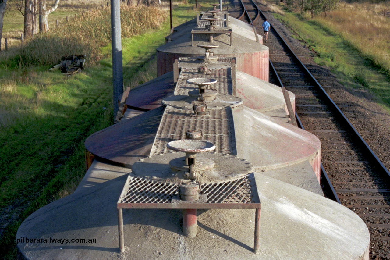 129-1-12
Lyndhurst, detail roof view of V/Line broad gauge VPCX type bogie cement waggons. Location is [url=https://goo.gl/maps/APmJrHjskZH4gvxa6]Geo Data[/url].
Keywords: VPCX-type;