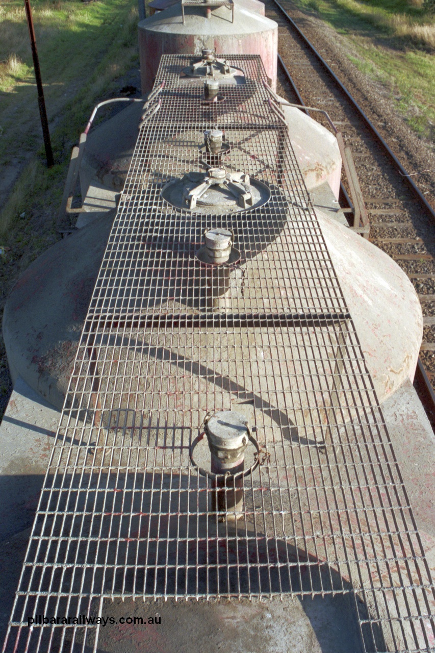 129-1-13
Lyndhurst, detail roof view of V/Line broad gauge VPCX type bogie cement waggons, shows wider and higher rectangular style grid mesh. Location is [url=https://goo.gl/maps/APmJrHjskZH4gvxa6]Geo Data[/url].
Keywords: VPCX-type;