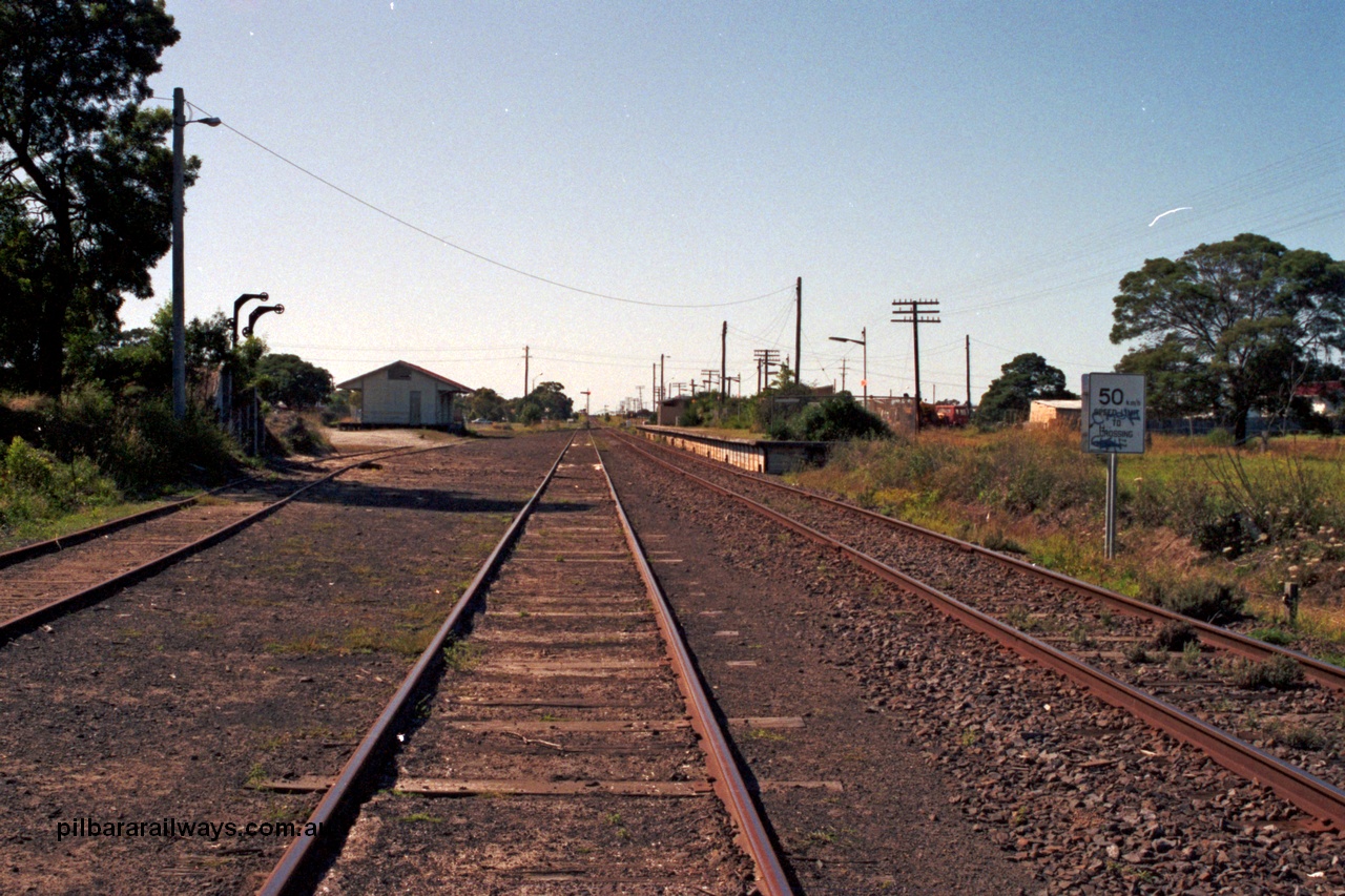 129-1-33
Cranbourne station overview, looking towards Koo Wee Rup, loading ramp and goods shed on the left, station platform and building on the right.
