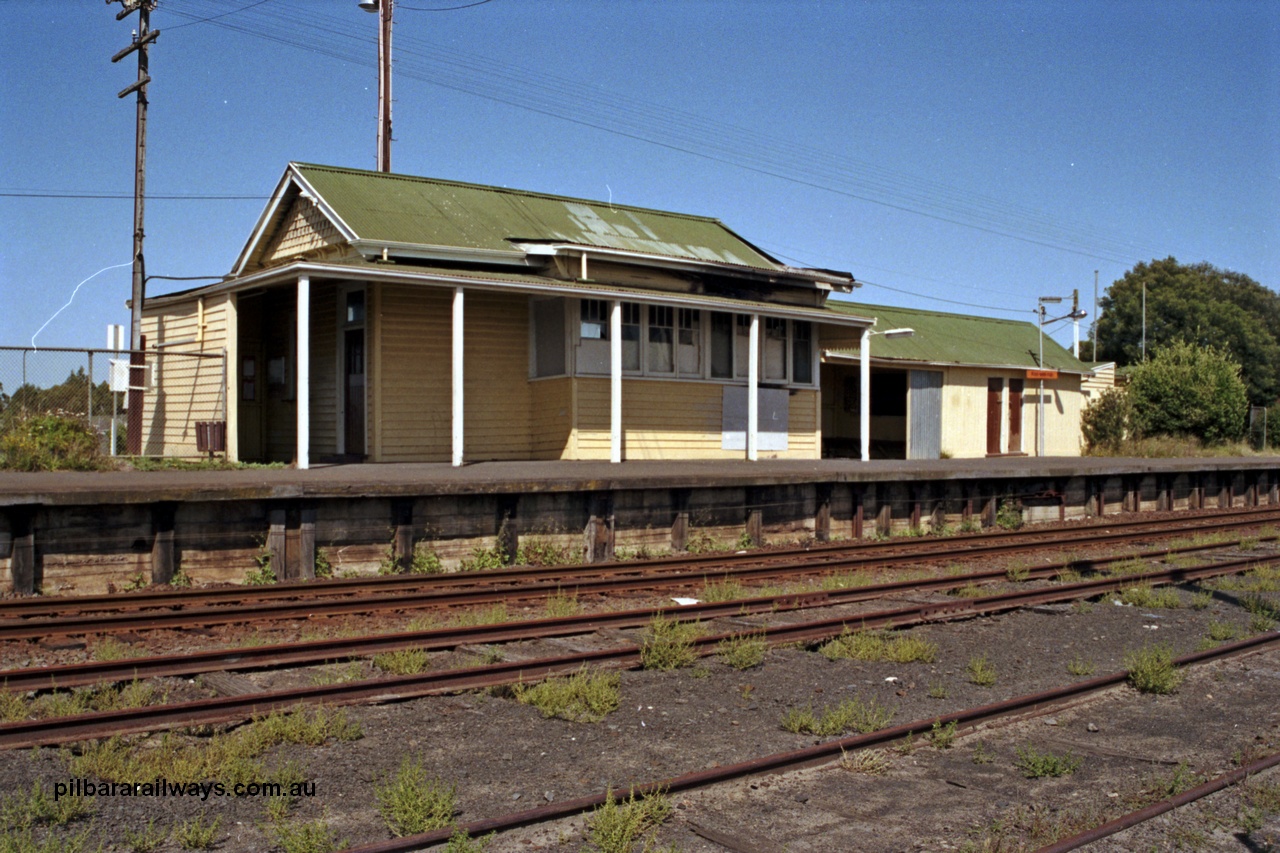 129-1-35
Koo Wee Rup station building overview, station platform, building showing signs of fire damage, track view.
