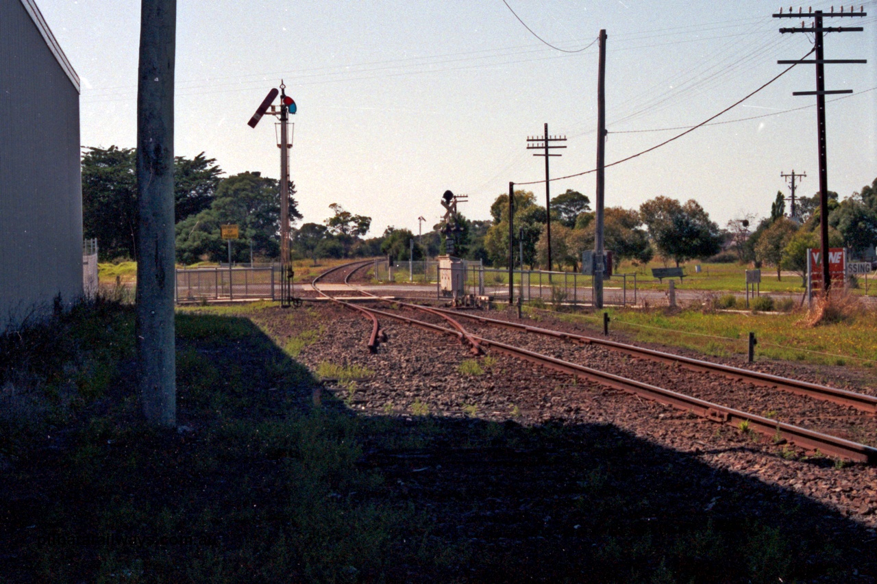 129-1-36
Koo Wee Rup track view, looking in the down direction towards Lang Lang across Rossiter Road, semaphore signal, track segment removed. [url=https://goo.gl/maps/MChmwk7sx8yYrrxR7]Location is here[/url].
