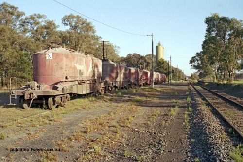 129-1-15
Lyndhurst, station overview, V/Line VPCX type bogie cement waggons in rakes, platform on RHS, looking towards Melbourne, Blue Circle Cement plant in the background. Location is [url=https://goo.gl/maps/4zF5DDSnJN6R9cKe8]Geo Data[/url].
Keywords: VPCX-type;