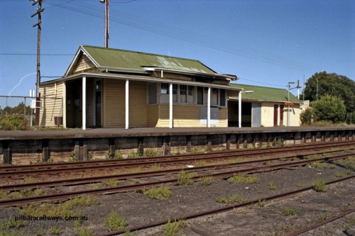 129-1-35
Koo Wee Rup station building overview, station platform, building showing signs of fire damage, track view.
