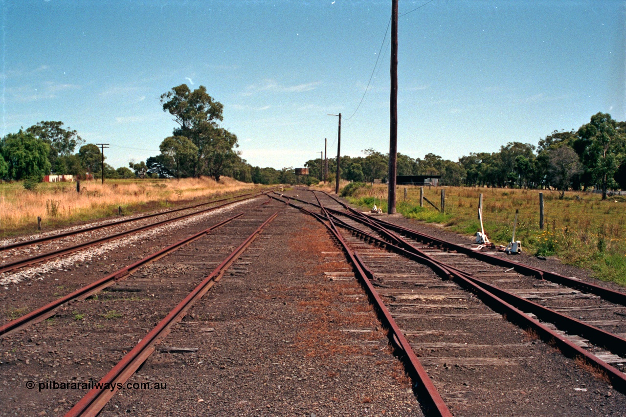 129-2-08
Nyora yard overview, looking in the up direction towards Melbourne, right road leads to turntable, water tank, tracks removed, double compound points.
