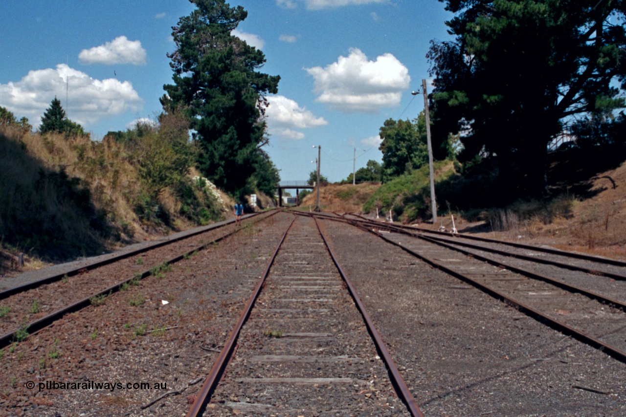 129-2-23
Leongatha yard view looking down direction from near the end of the platform. Ogilvy or Bair St bridge in the distance.
