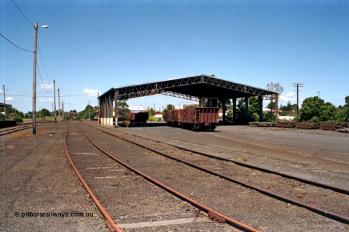 129-2-19
Korumburra station yard overview, showing Freightgate canopy, sleeper waggons, goods shed behind, looking in the down direction.
