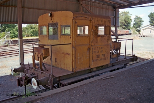 129-2-30
Leongatha yard view, Victorian Railways liveried broad gauge RT class rail tractor RT 39 still with buffers, under goods loading canopy, station and stabled train in background.
Keywords: RT-class;RT39;