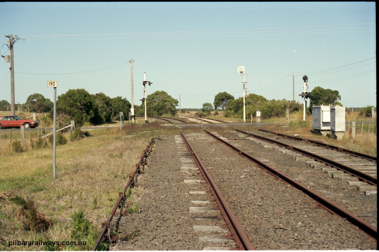 129-3-13
Barry Beach Junction track view, 190 km, road crossing, Welshpool - Yarram curves to the left, Barry Beach to the right.
