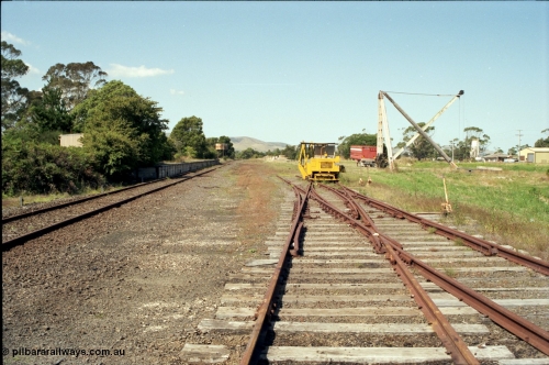 129-3-03
Foster yard overview, Melbourne end looking towards Toora, sleeper inserting machine, timber derrick crane, tracks removed, double compound points and levers.
