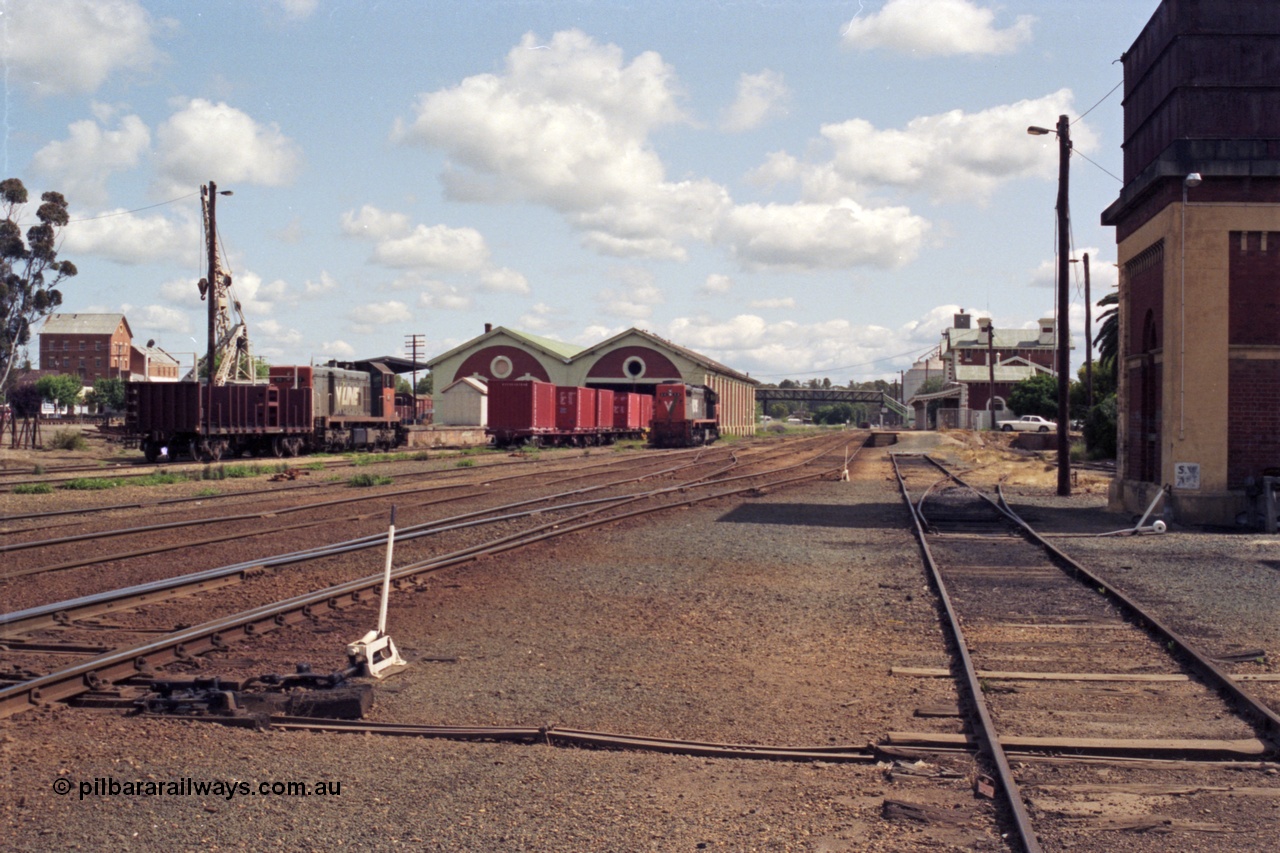 131-1-08
Echuca yard overview, looking north, V/Line broad gauge class leaders of the H class H 1 Clyde Engineering EMD model G18B serial 68-629 and the X class X 31 Clyde Engineering EMD model G16C serial 66-484, goods shed, station building, water tower at right, point levers, track work.
