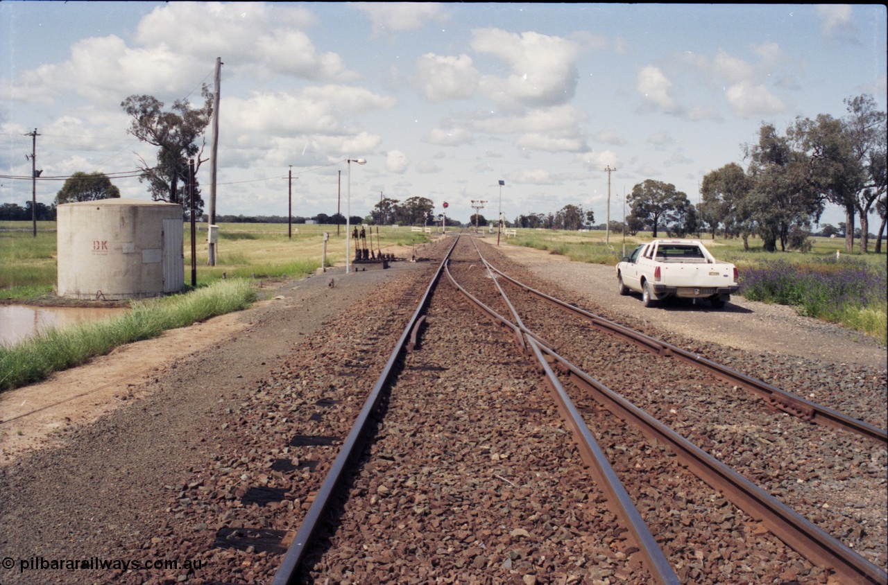 131-1-12
Barnes, track view, looking south from junction points, searchlight and semaphore signals, signal and point levers, standing on the Deniliquin line, Balranald line at right.
