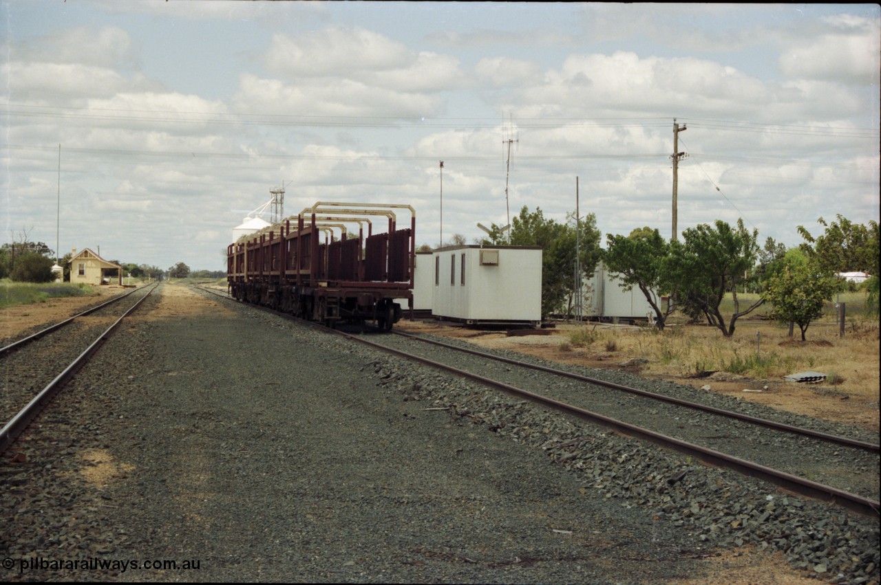 131-1-18
Wakool yard overview, sleeper waggons, gang camp portable dwellings, station building at left, looking south.
