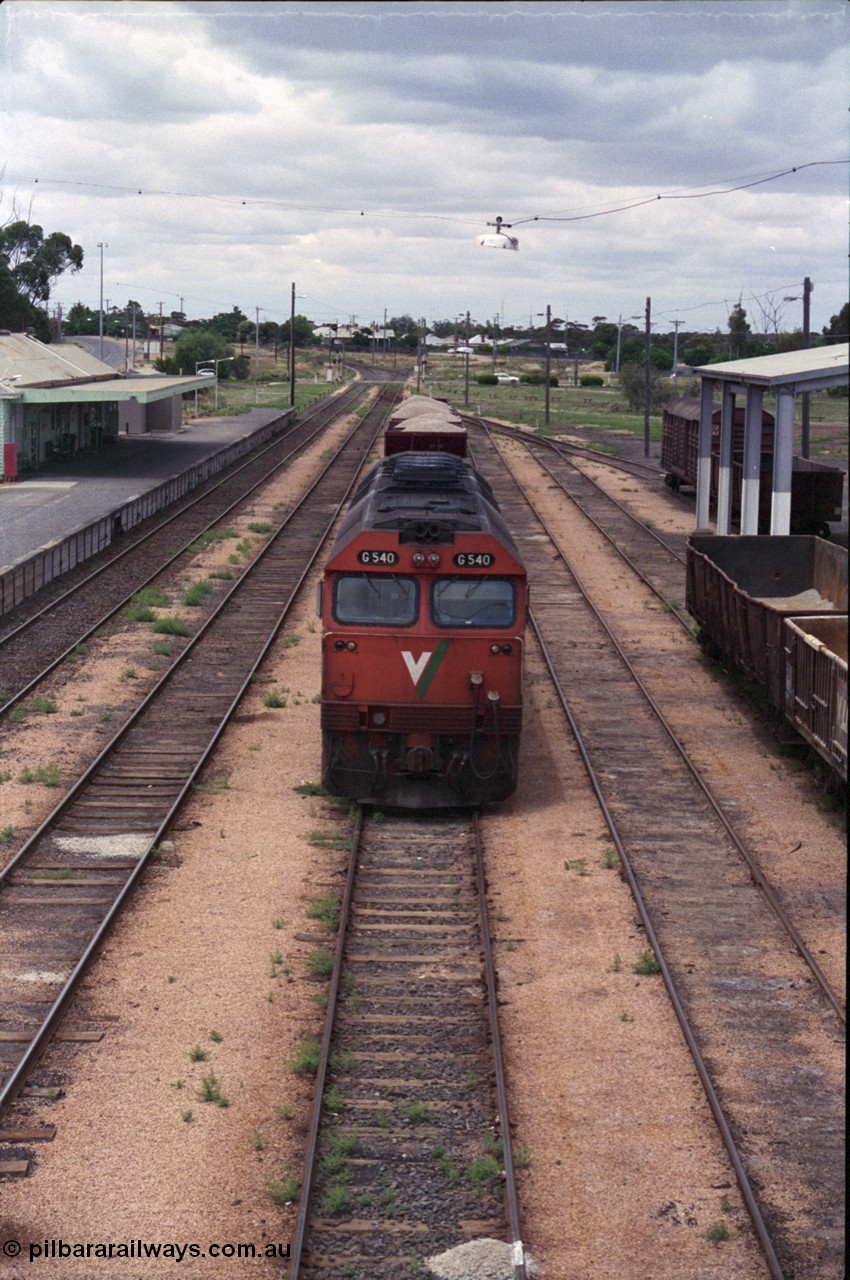 132-06
Ouyen station overview, broad gauge V/Line G class G 540 Clyde Engineering EMD model JT26C-2SS serial 89-1273 with stabled up gypsum train 9138, looking south from footbridge, station building and platform, Freightgate canopy.
Keywords: G-class;G540;Clyde-Engineering-Somerton-Victoria;EMD;JT26C-2SS;89-1273;