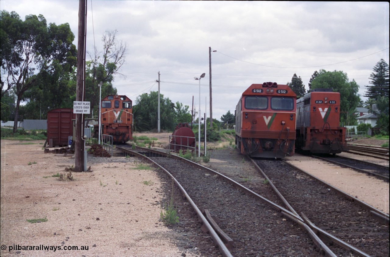 132-22
Mildura loco depot, looking north, grounded B van, brake pit, V/Line broad gauge locos, Y class Y 165 Clyde Engineering EMD model G6B serial 68-585, G class G 512 Clyde Engineering EMD model JT26C-2SS serial 84-1240 and X class X 32 Clyde Engineering EMD model G16C serial 66-485.
Keywords: G-class;G512;Clyde-Engineering-Rosewater-SA;EMD;JT26C-2SS;84-1240;