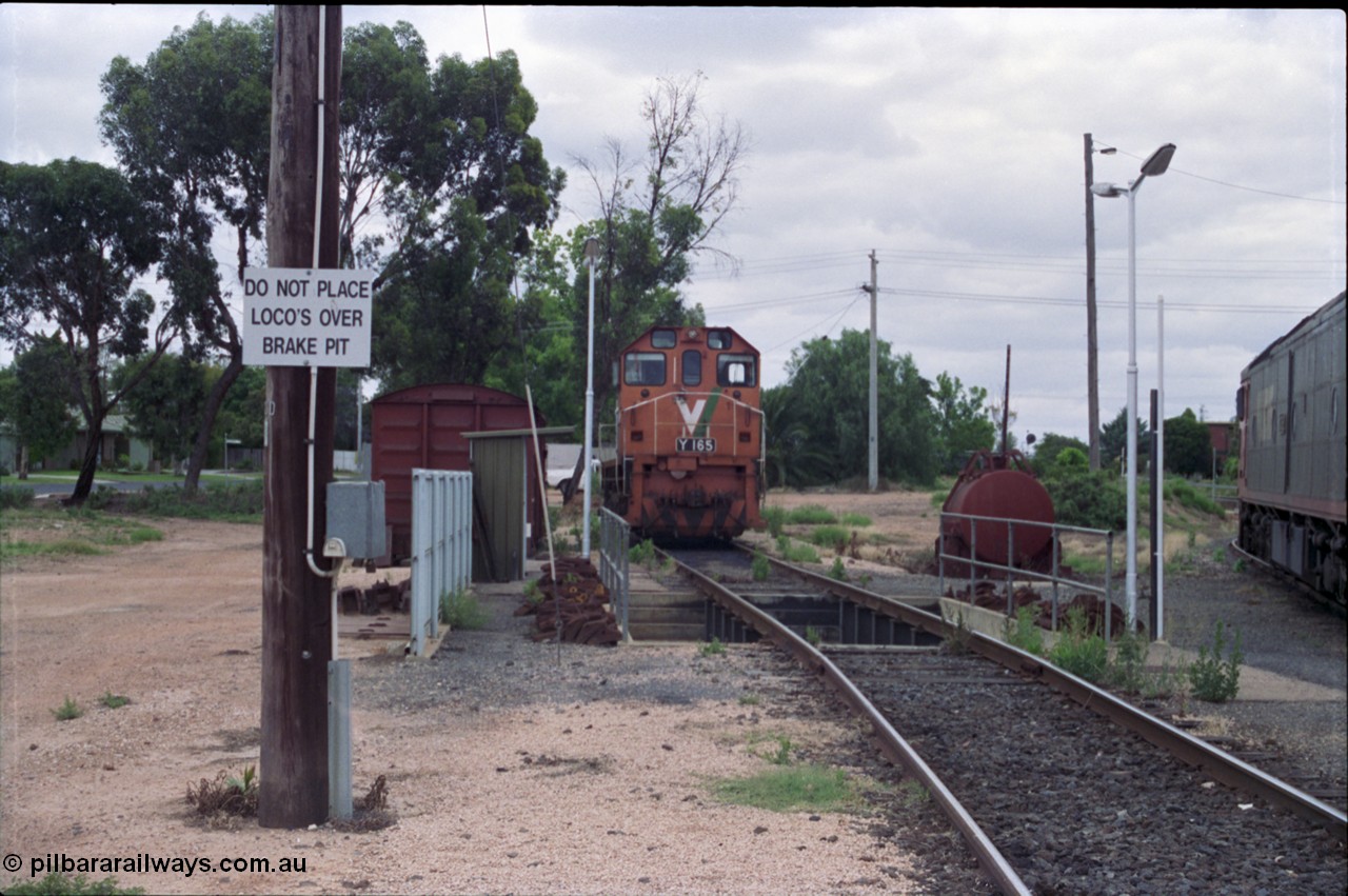 132-23
Mildura loco depot, looking north, grounded B van, brake pit, V/Line broad gauge Y class Y 165 Clyde Engineering EMD model G6B serial 68-585.
Keywords: Y-class;Y165;Clyde-Engineering-Granville-NSW;EMD;G6B;68-585