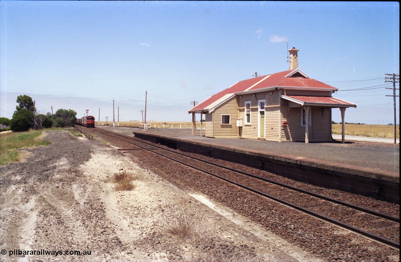133-15
Gheringhap station building overview, grain train arriving, looking towards Geelong.
