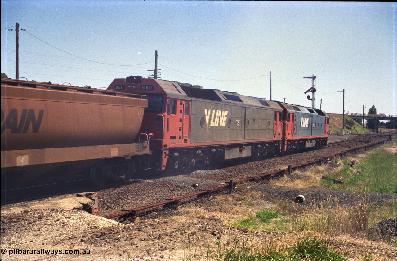 133-19
Gheringhap, V/Line broad gauge grain train 9121 departing for the Ballarat line, point rodding, semaphore signal post 4 pulled off for move, G class locos G 529 Clyde Engineering EMD model JT26C-2SS serial 88-1259 and G 511 serial 84-1239, trailing view.
Keywords: G-class;G511;Clyde-Engineering-Rosewater-SA;EMD;JT26C-2SS;84-1239;