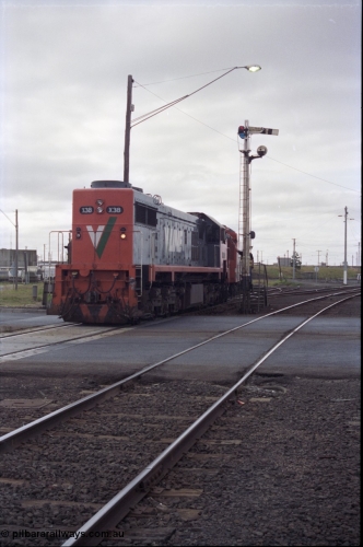 133-07
North Geelong C Box, Separation Street grade crossing, V/Line broad gauge down Ararat passenger train 8105 powered by long end leading X class X 38 Clyde Engineering EMD model G26C serial 70-701 obtains the electric staff for the section to Gheringhap, semaphore signal post 16, signaller, staff exchange, safeworking.
Keywords: X-class;X38;Clyde-Engineering-Granville-NSW;EMD;G26C;70-701;