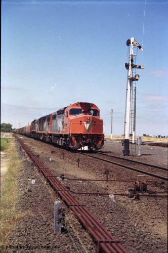 133-27
Gheringhap, V/Line broad gauge locos C class leader C 501 'George Brown' Clyde Engineering EMD model GT26C serial 76-824 leads C 506 serial 76-829 and X class X 45 'Edgar H Brownbill' Clyde Engineering EMD model G26C serial 75-792 with train 9169 down Adelaide goods, departing with a train order for Maroona, station overview, point rodding and signal wires, semaphore signal post 4 pulled off for the Cressy line, interlocking.
Keywords: C-class;C501;Clyde-Engineering-Rosewater-SA;EMD;GT26C;76-824;