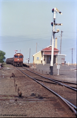 133-32
Gheringhap station yard overview, looking from Ballarat line points towards Geelong, semaphore signal post 4 pulled off for Cressy line, points, point rodding, signal wires and interlocking, V/Line broad gauge grain train 9123 swapping electric staff for train order for Maroona, safeworking.
Keywords: G-class;G533;Clyde-Engineering-Somerton-Victoria;EMD;JT26C-2SS;88-1263;