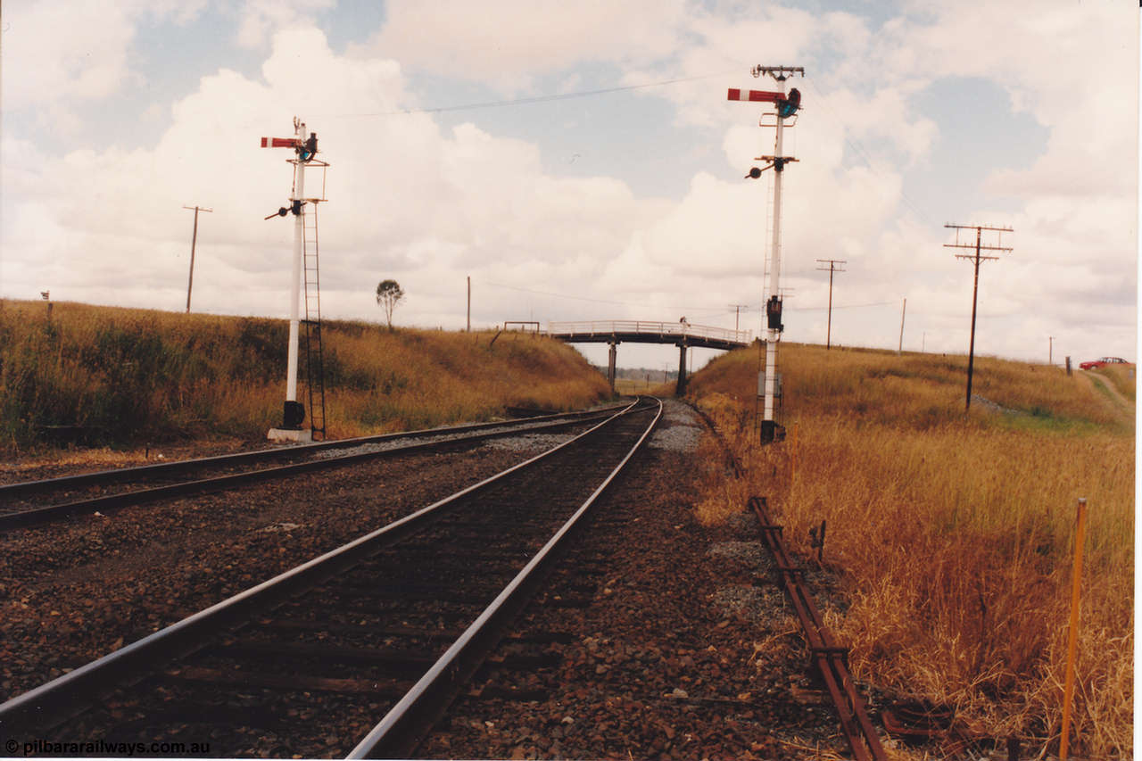 134-03
Kagaru, up departure signals, looking south at the south end, road over bridge, point rodding.
