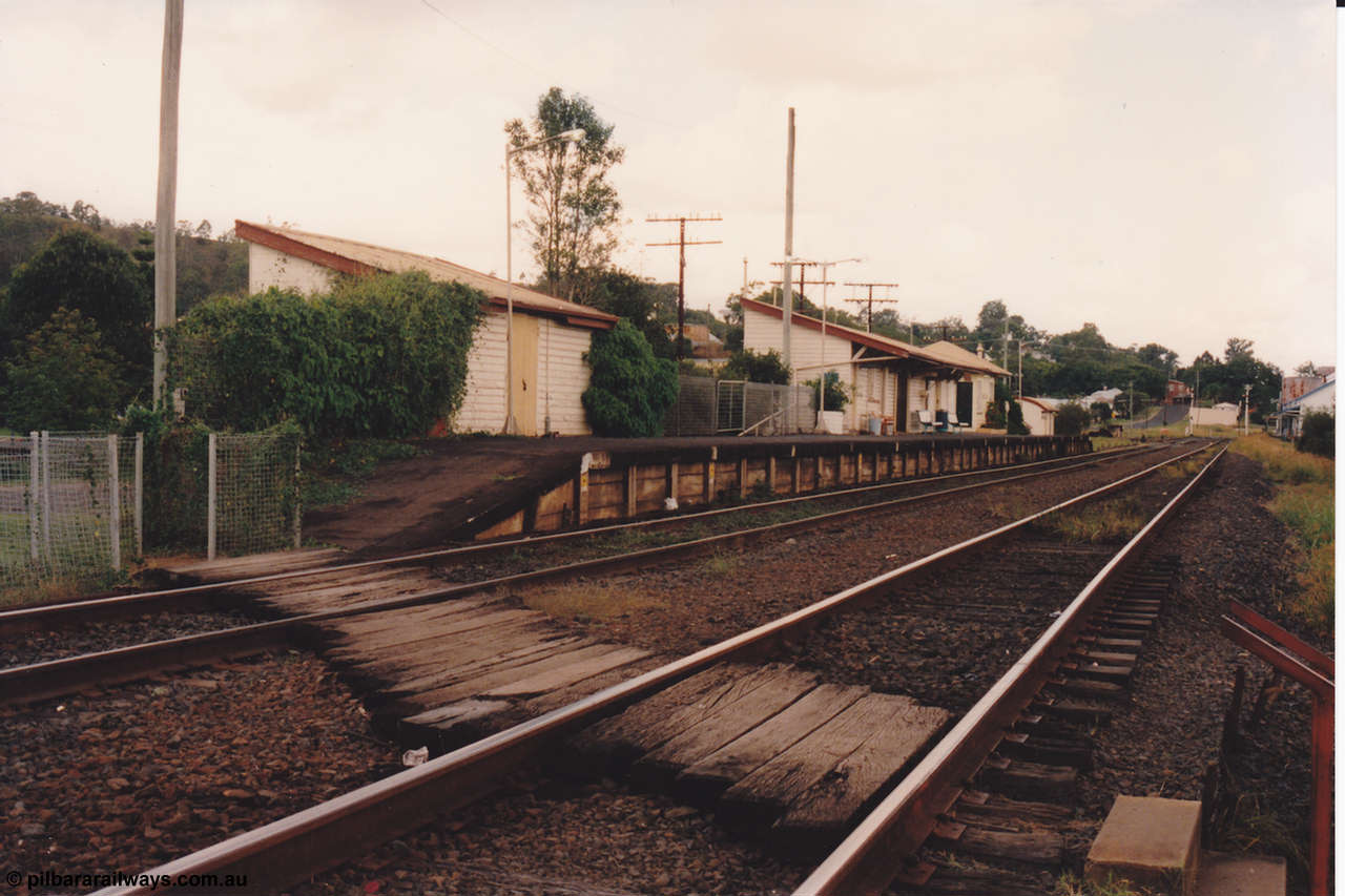 134-18
Kyogle, station building overview, goods shed, waiting room, signal box, timber crossing, platform, looking south.
