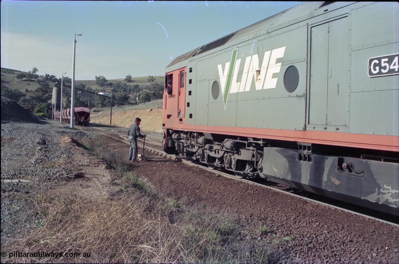 135-16
Kilmore East Apex Quarry siding overview, 2nd person operating points, V/Line broad gauge G class G 540 Clyde Engineering EMD model JT26C-2SS serial 89-1273 runs around rake, loading bins in background.
Keywords: G-class;G540;Clyde-Engineering-Somerton-Victoria;EMD;JT26C-2SS;89-1273;