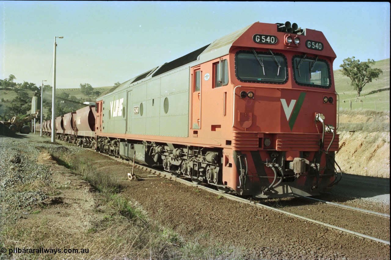 135-21
Kilmore East Apex Quarry siding, V/Line broad gauge G class G 540 Clyde Engineering EMD model JT26C-2SS serial 89-1273 on the front of the stone train as it is loaded by the front-end wheel loader.
Keywords: G-class;G540;Clyde-Engineering-Somerton-Victoria;EMD;JT26C-2SS;89-1273;