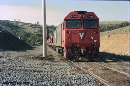 135-18
Kilmore East Apex Quarry siding, V/Line broad gauge G class G 540 Clyde Engineering EMD model JT26C-2SS serial 89-1273 on the front of the stone train as it is loaded by the front-end wheel loader.
Keywords: G-class;G540;Clyde-Engineering-Somerton-Victoria;EMD;JT26C-2SS;89-1273;