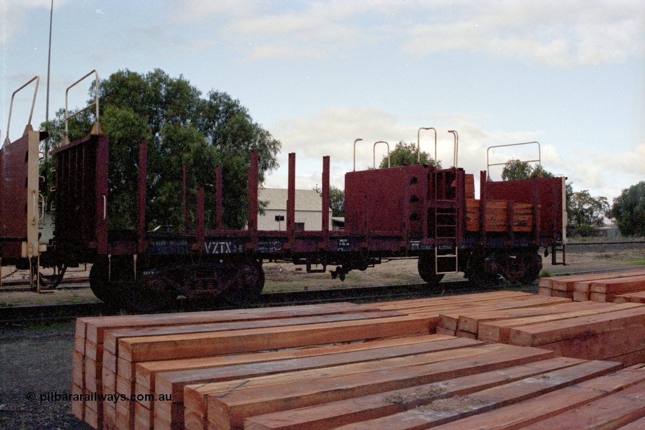 136-02
Mathoura, broad gauge V/Line VZTX class bogie sleeper carrying waggon VZTX 3 half loaded, new sleepers stockpiled in yard.
Keywords: VZTX-type;VZTX3;