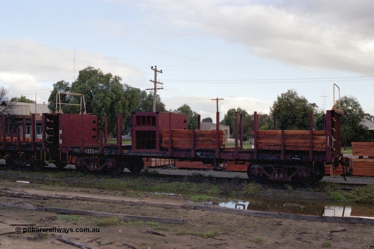 136-03
Mathoura, broad gauge V/Line VZTX class bogie sleeper carrying waggon VZTX 6 half loaded, new sleepers stockpiled in yard.
Keywords: VZTX-type;VZTX6;