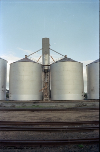 136-18
Deniliquin Ascom style silo complex, track view, loading spout and surge silo.
