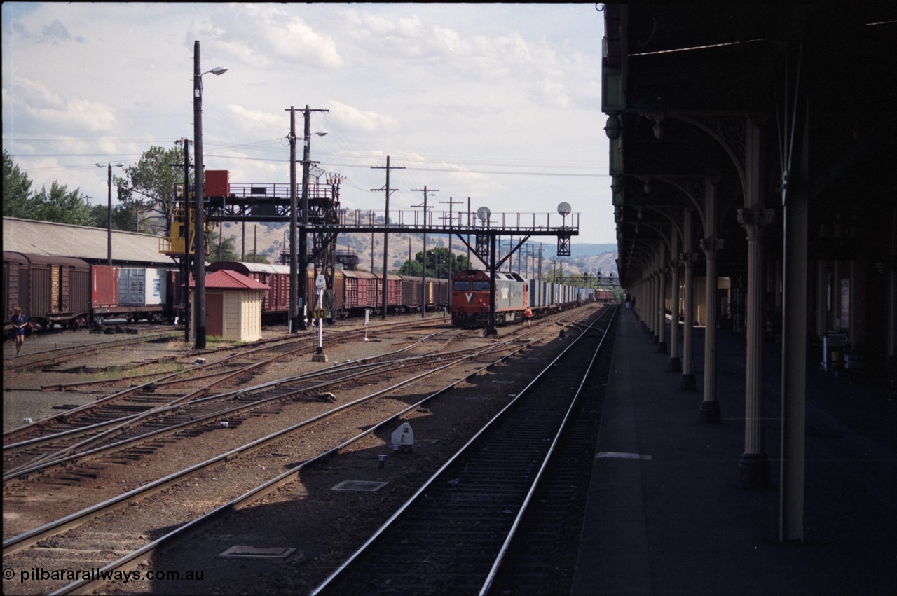 137-2-04
Albury station yard overview, standard gauge V/Line G class loco G 518 Clyde Engineering EMD model JT26C-2SS serial 85-1231 has just arrived with down goods from Melbourne, the G class will cut off and run to loco. Immediately to the left of the G class is the broad gauge goods loop.
Keywords: G-class;G518;Clyde-Engineering-Rosewater-SA;EMD;JT26C-2SS;85-1231;