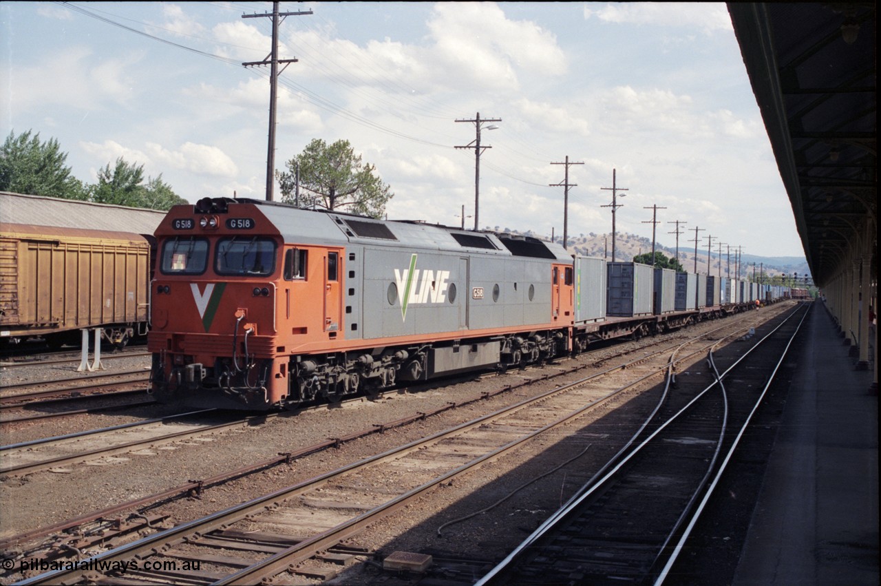 137-2-05
Albury station yard view, V/Line standard gauge locomotive G class G 518, Clyde Engineering EMD model JT26C-2SS serial 85-1231, has arrived with a down goods from Melbourne and waits to cut off as was the standard practice of the era, NSW will then re-marshall the consist for the trip to Sydney.
Keywords: G-class;G518;Clyde-Engineering-Rosewater-SA;EMD;JT26C-2SS;85-1231;