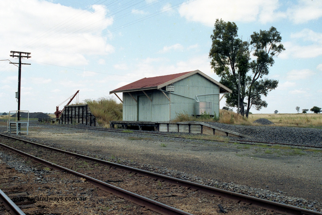 138-23
Talbot, yard overview, staff exchange platform, on loop, yard crane and platform, loading ramp, goods shed and platform, piles of ballast.
