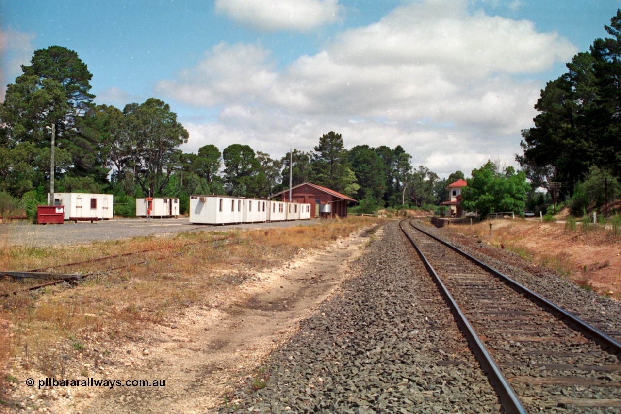 139-03
Creswick station yard overview, well what remains! Siding rail just visible in the grass, Looking north from the south end, lamp room, elevated signal box, station building, goods shed.
