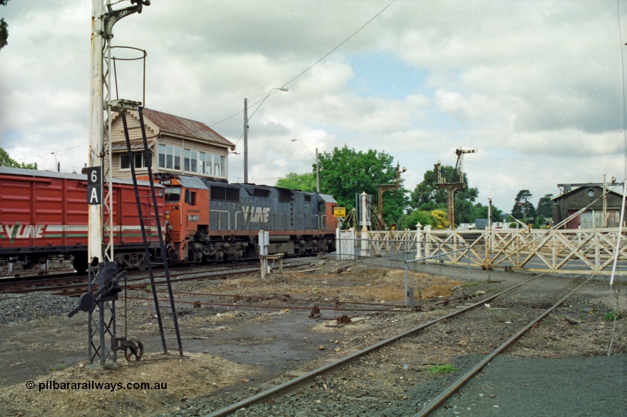 139-09
Ballarat East, Humffray Street, interlocked gates, V/Line broad gauge N class N 469 'City of Morwell' Clyde Engineering EMD model JT22HC-2 serial 86-1198 leads an up passenger train, the right hand set of interlocked gates are for the loco depot tracks, point rodding, signal post 6A.
Keywords: N-class;N469;Clyde-Engineering-Somerton-Victoria;EMD;JT22HC-2;86-1198;