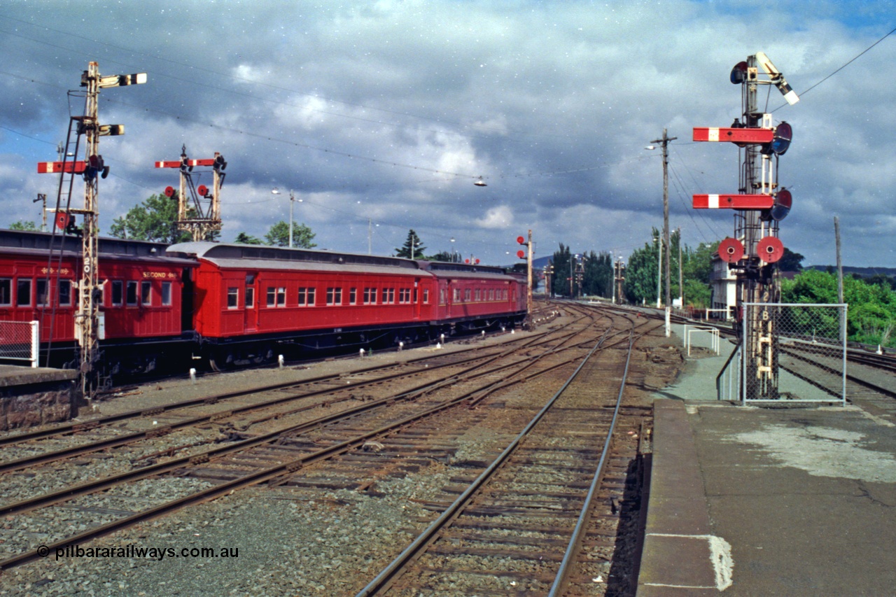 139-13
Ballarat station yard view looking east from Platform One, shows remains of the removed fourth track in foreground, K crossings still in situ, semaphore signal Posts 20, 19, 17, 21B, Post 21 behind Post 21B is pulled off a down Adelaide goods train.
