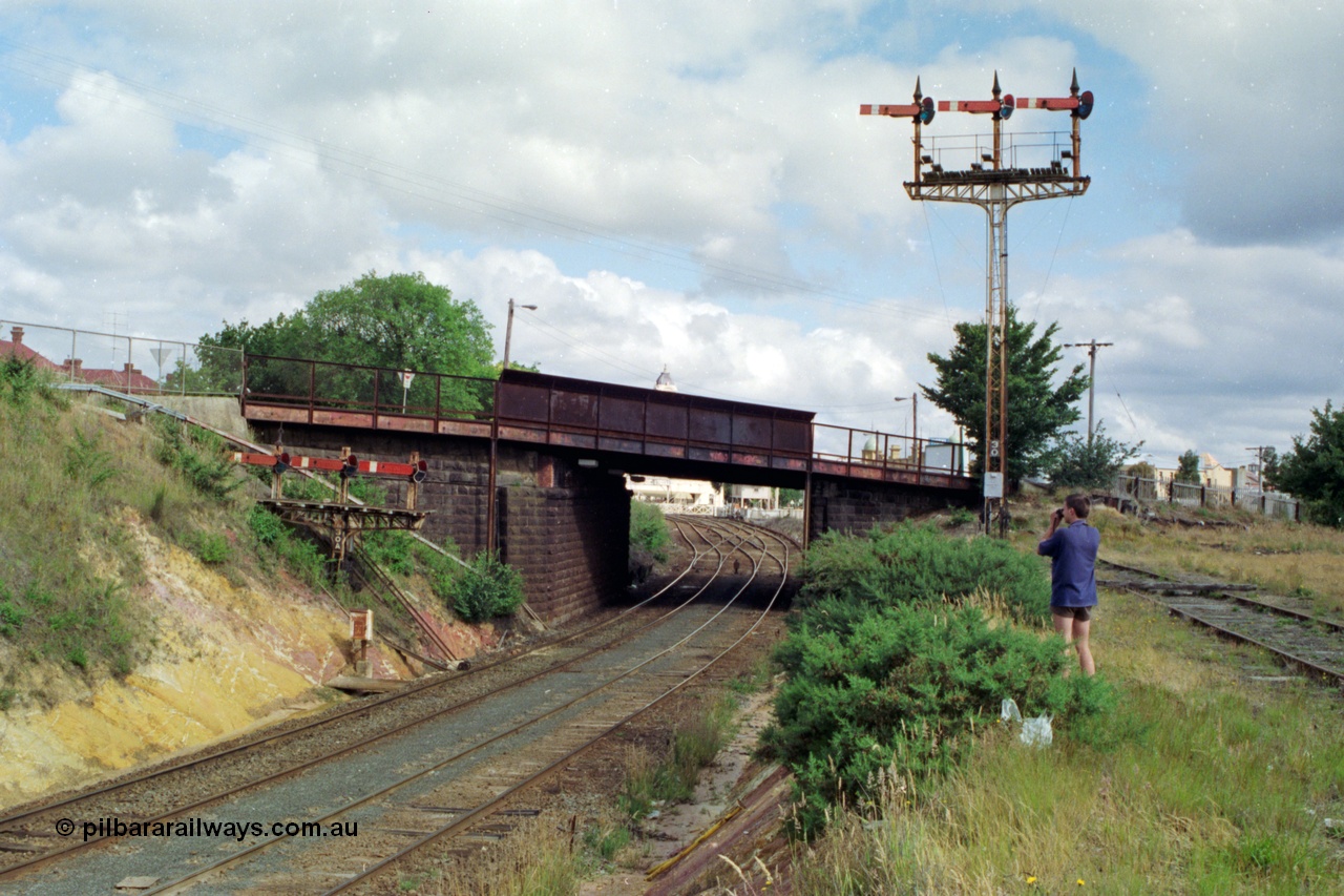 139-17
Ballarat, looking towards Lydiard St from Armstrong St bridge, semaphore signal Posts 30 and 30A, 30A are 'co-acting' signals for Post 30, operated from Ballarat Signal Box B at Lydiard St, this junction goes from double track to triple and used to be four roads through the station building. The manual interlocked gates of Lydiard St are just visible through the road overbridge. Left hand Arm Up Home Up Line to 'A' to Post 29 for No. 4 Road, middle Arm Up Home Up Line to 'B' to Post 27 or 28 for No. 3 or 2 Roads and the right Arm Up Home Up Line to 'C' to Post 26 for No. 1 Road.
