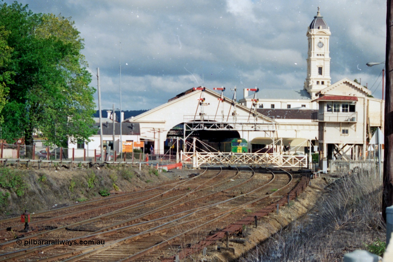 139-20
Ballarat, Australian National broad gauge BL class BL 32 Clyde Engineering EMD model JT26C-2SS serial 83-1016 leading a down Adelaide goods pauses at Ballarat station under the canopy and clock tower, view of Lydiard Street Ballarat B signal box, interlocked gates and semaphore signal gantry, 119 km post, looking east.
Keywords: BL-class;BL32;Clyde-Engineering-Rosewater-SA;EMD;JT26C-2SS;83-1016;