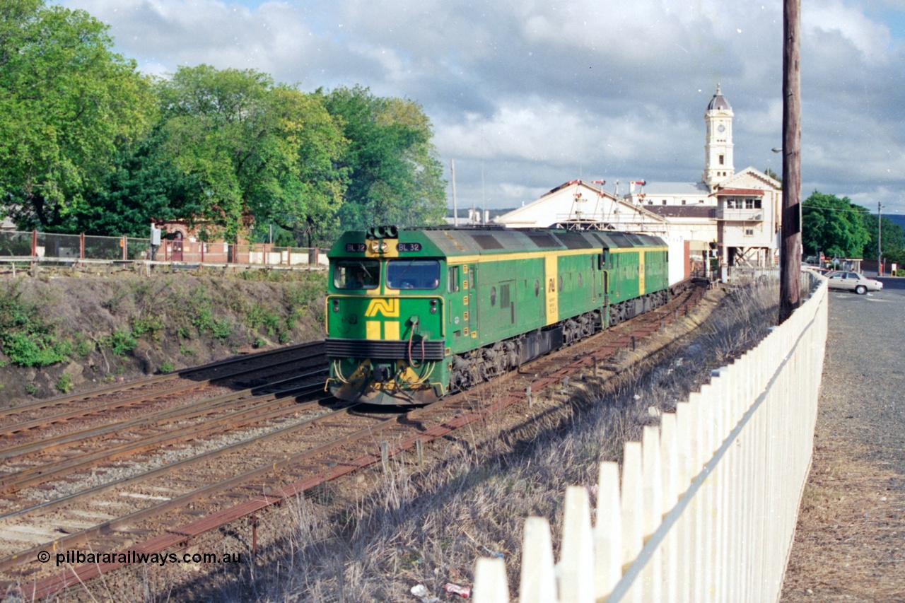 139-22
Ballarat station, Australian National broad gauge BL class BL 32 Clyde Engineering EMD model JT26C-2SS serial 83-1016 leading a down Adelaide bound goods train with a sister unit departing the station precinct, passing Lydiard Street Ballarat B signal box under the semaphore signal gantry.
Keywords: BL-class;BL32;Clyde-Engineering-Rosewater-SA;EMD;JT26C-2SS;83-1016;