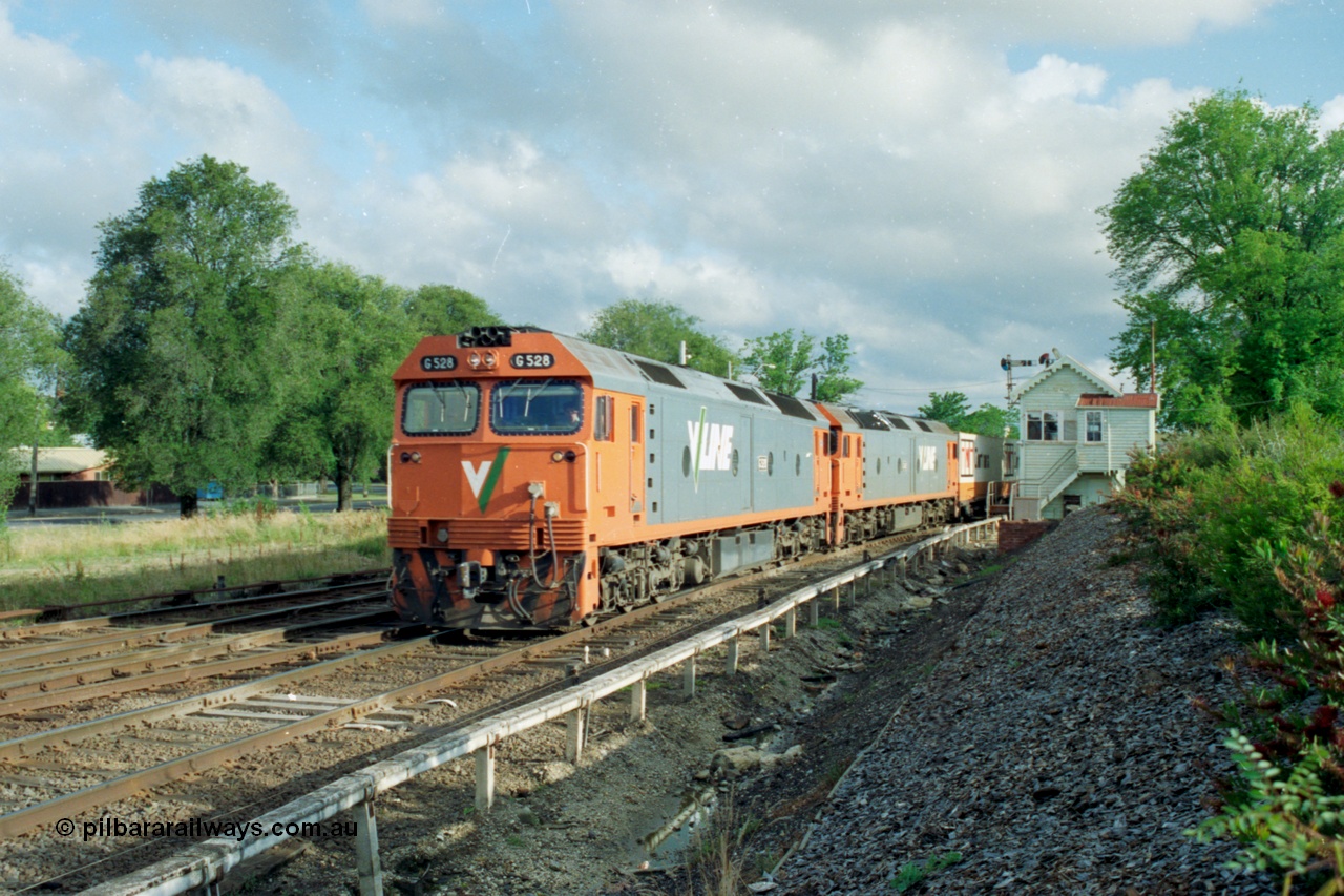 139-25
North Ballarat or Ballarat C Signal Box, broad gauge V/Line G class pair with G 528 Clyde Engineering EMD model JT26C-2SS serial 88-1258 leads an Adelaide bound down goods train, the track at the far left leads to Maryborough while the  middle track branches to Ballarat North Workshops.
Keywords: G-class;G528;Clyde-Engineering-Somerton-Victoria;EMD;JT26C-2SS;88-1258;